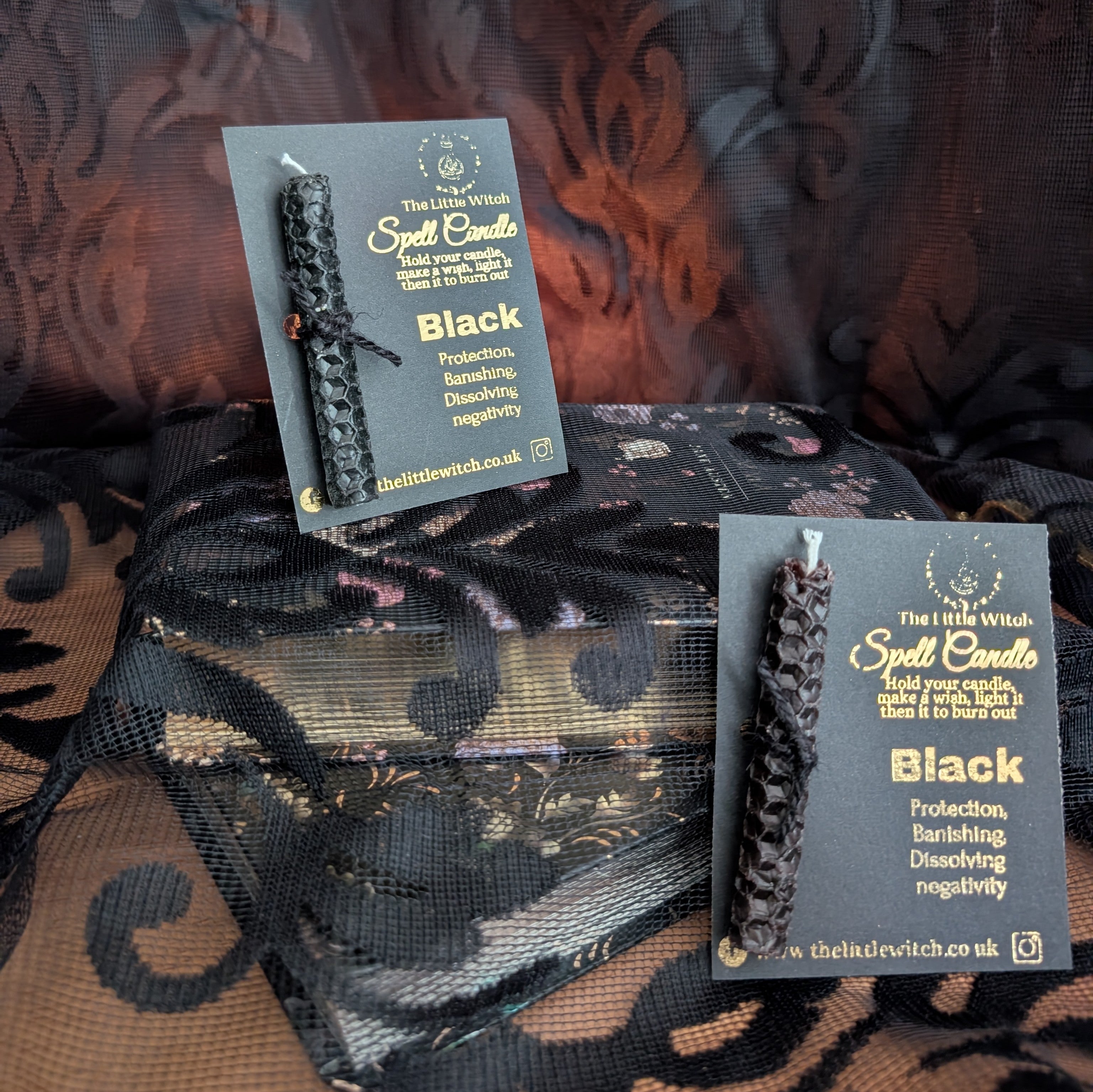 2 hand rolled beeswax spell candles mounted on branded black and gold card