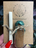 A glass vial filled with cinnamon to be known into the home on the 1st of each month 