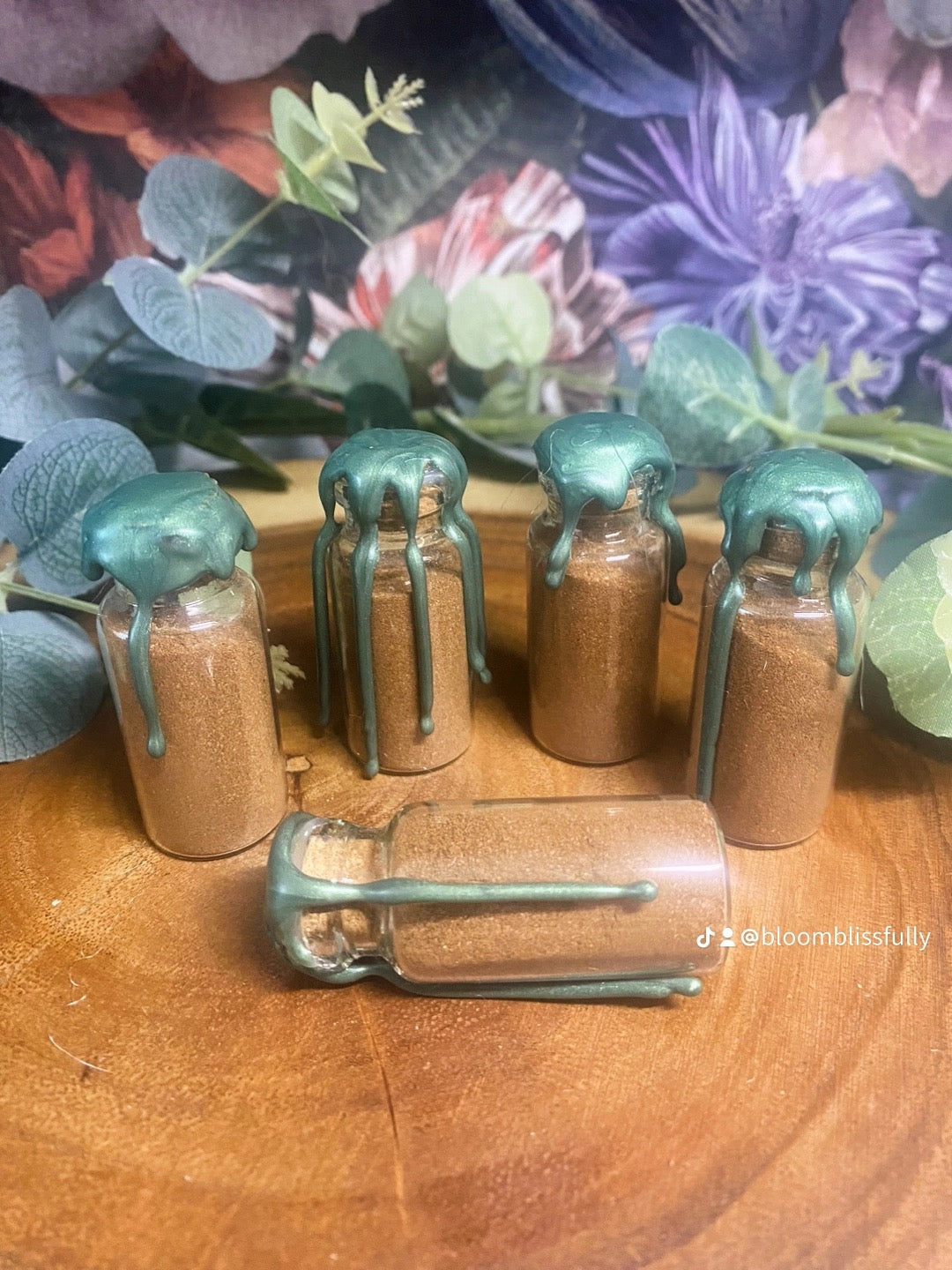 5 glass vials of cinnamon, each with the intention of blowing into the home on the 1st of each month 
