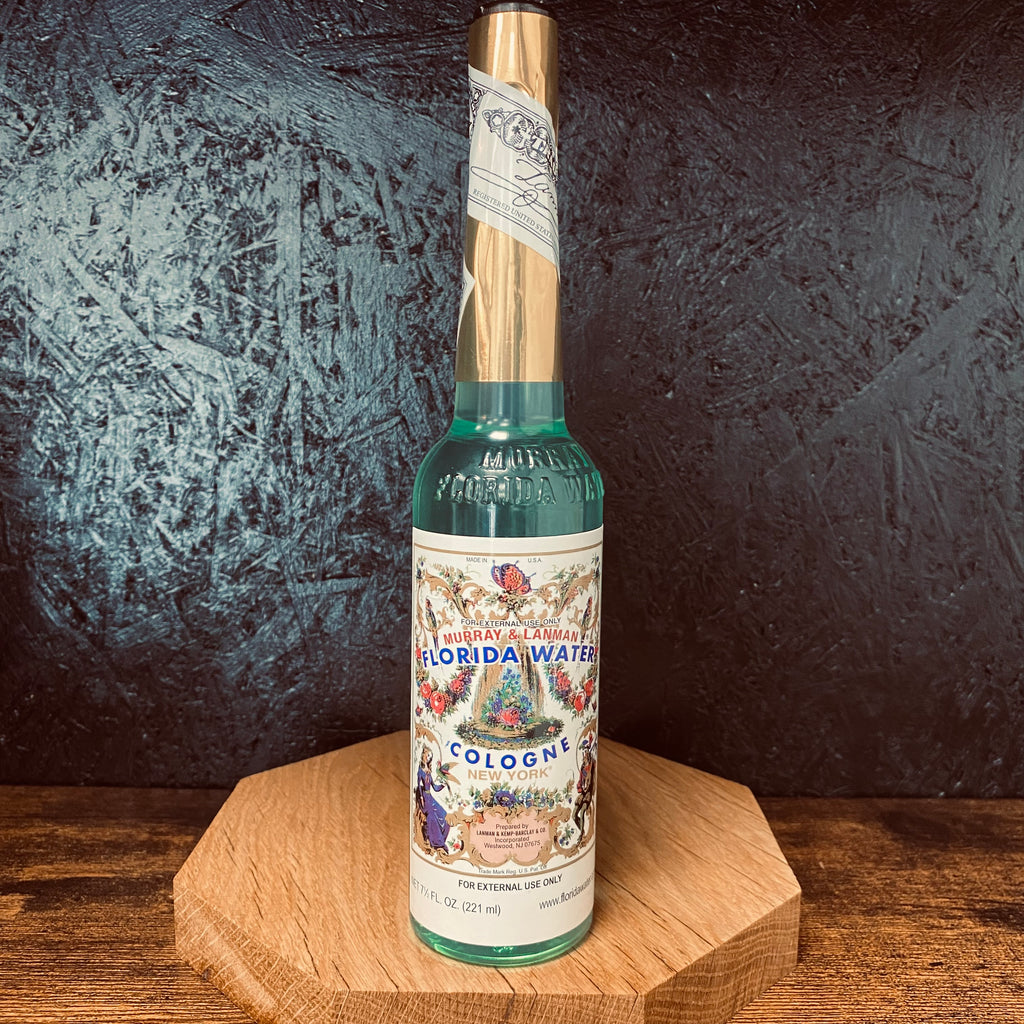 A bottle of Florida Water with a black textured background 