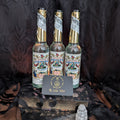 Three bottles of 'Florida Water' with decorative labels on a dark textured surface.