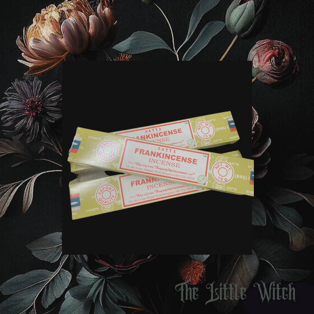 Packaging of frankincense incense sticks with branding visible, placed on a background with floral elements.