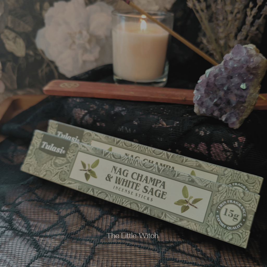 Box of Tulasi Nag Champa & White Sage incense sticks with a candle and amethyst stone in the background.