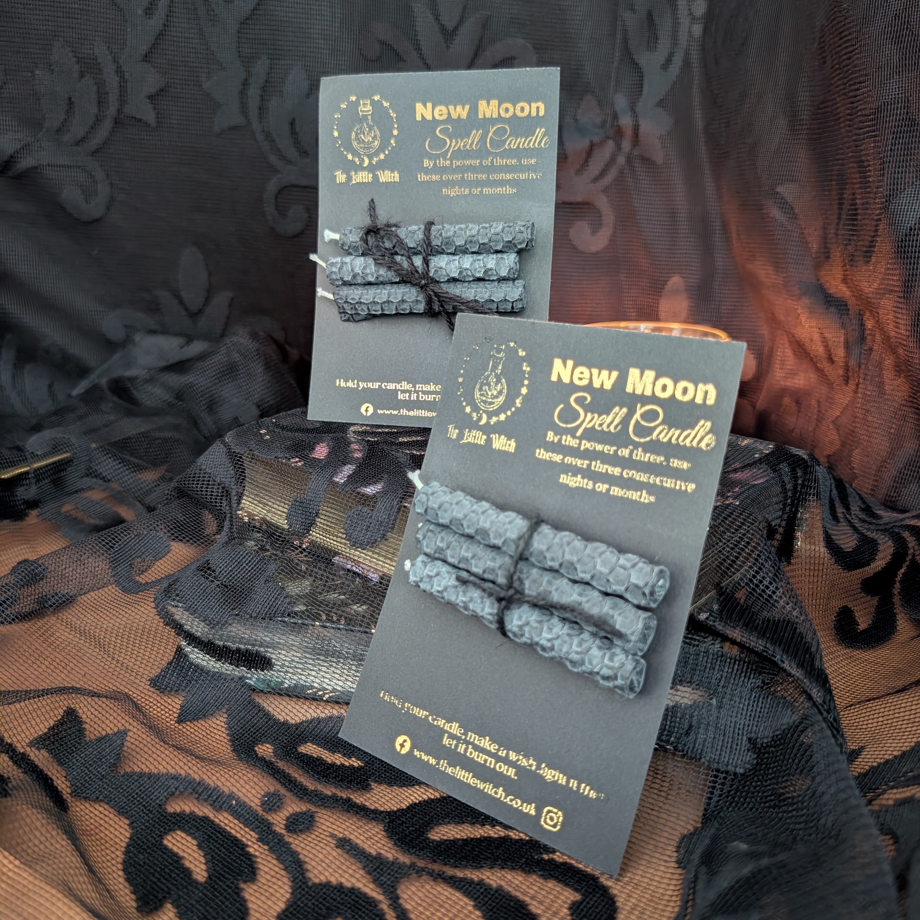 a pair of New Moon candle sets on black card with gold 'The Little Witch' branding