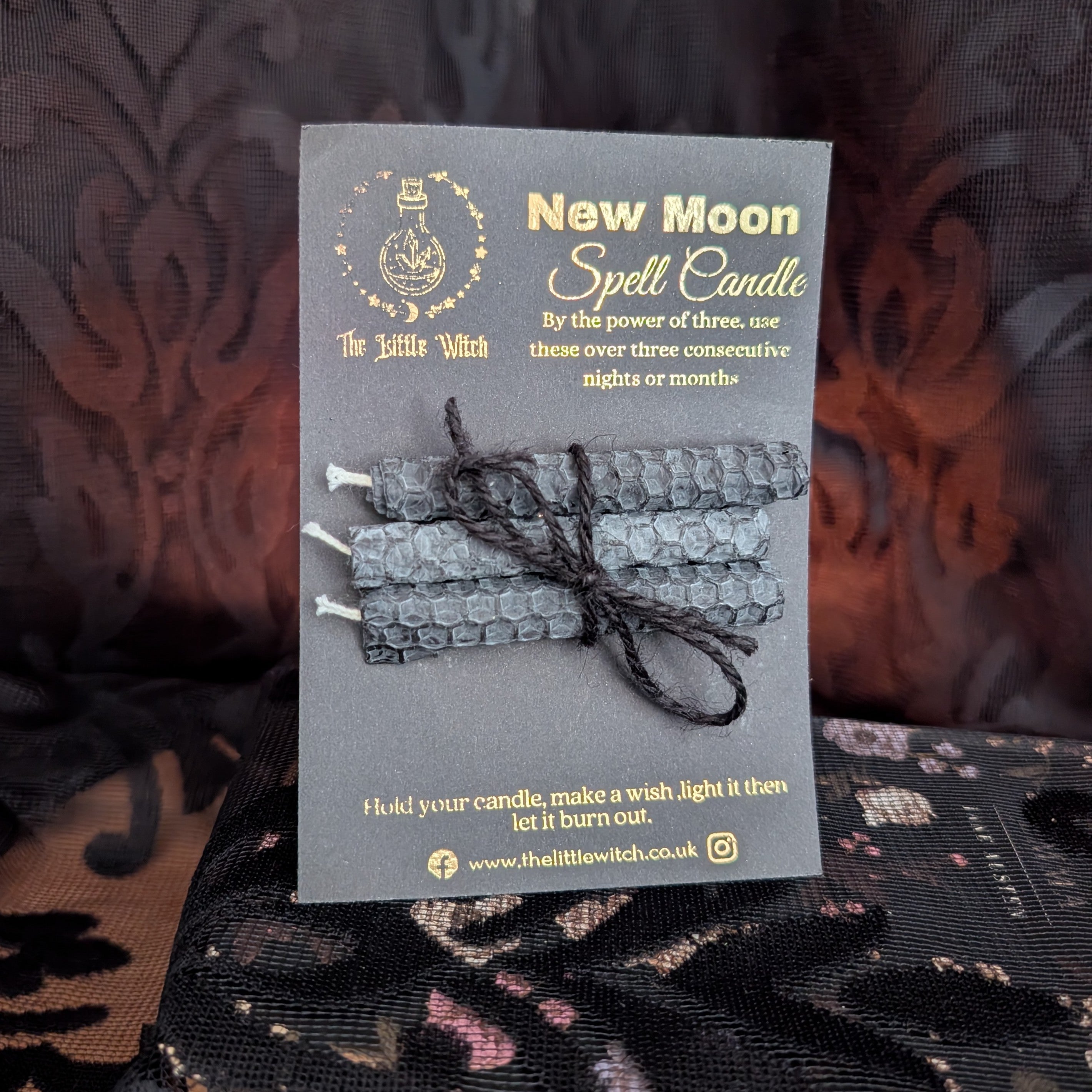 A set of 3 black beeswax candles mounted onto black card with gold 'The Little Witch' branding