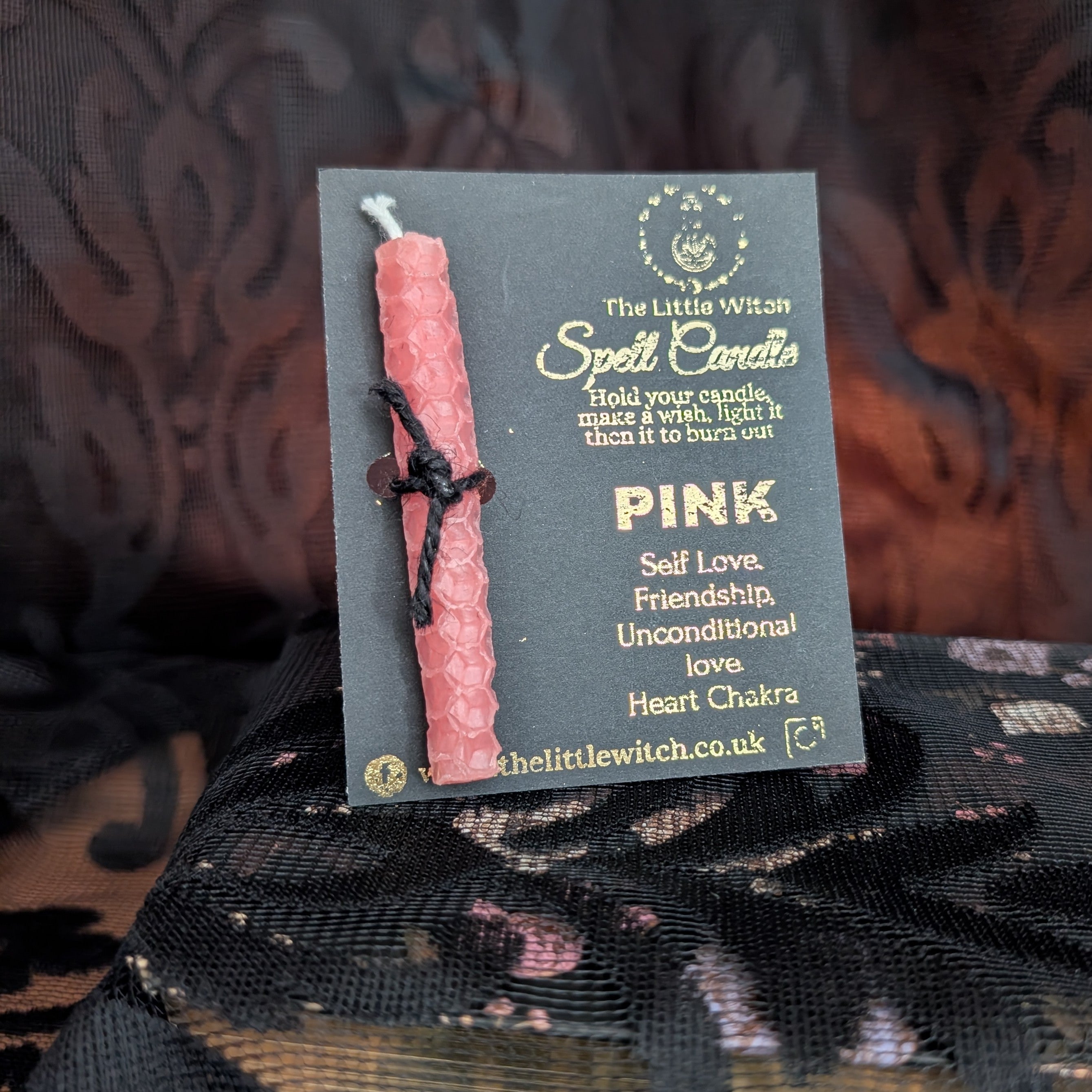 Pink hand rolled beeswax candle mounted on a The Little Witch black and gold card