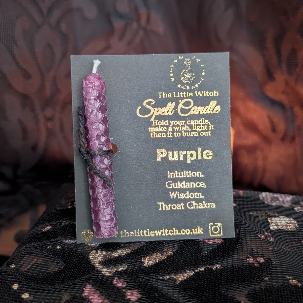 Purple beeswax candle mounted on a branded The Little Witch black and gold card