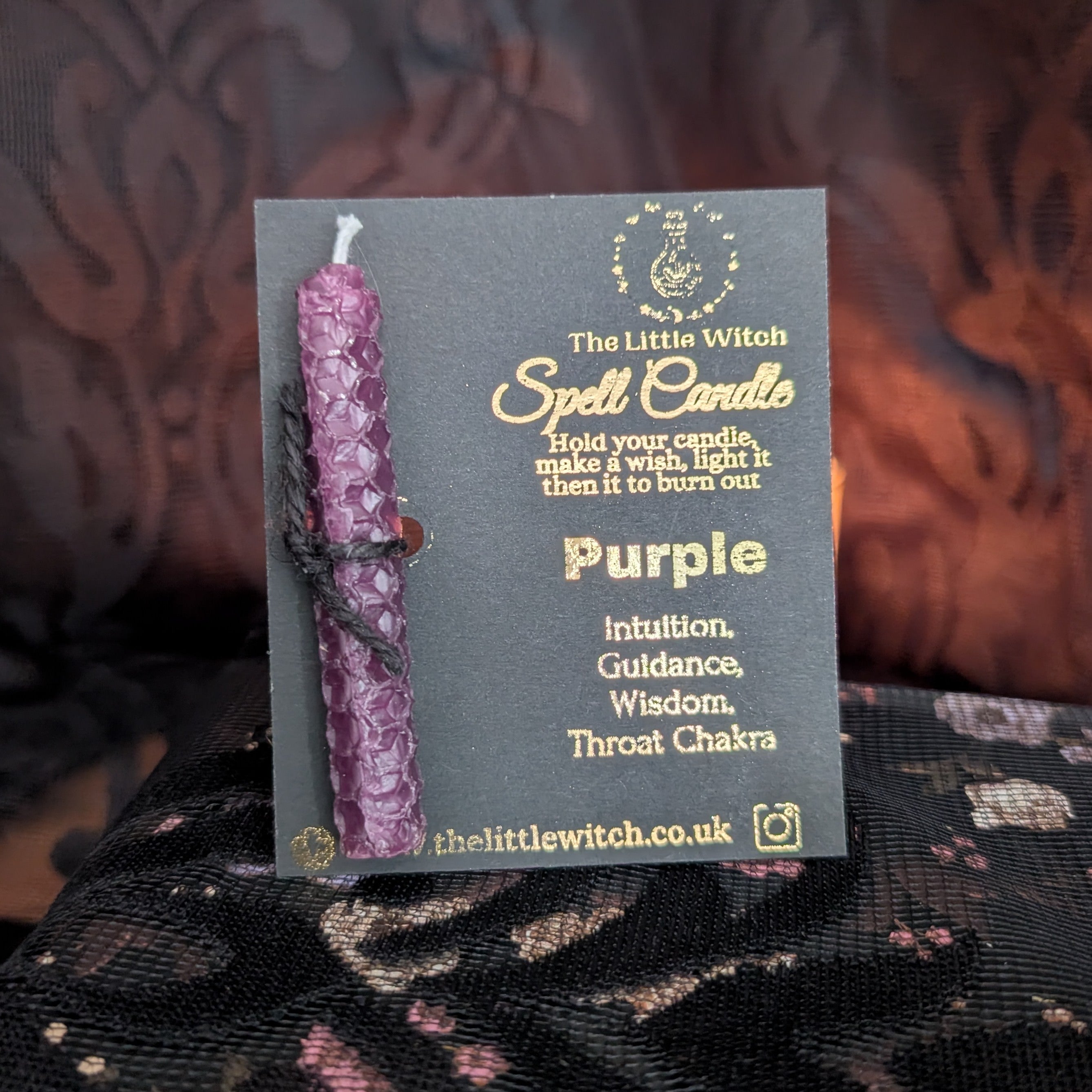 Purple beeswax candle mounted on a branded The Little Witch black and gold card