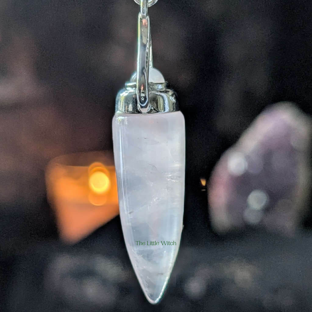 Crystal pendant with silver top on a blurred background