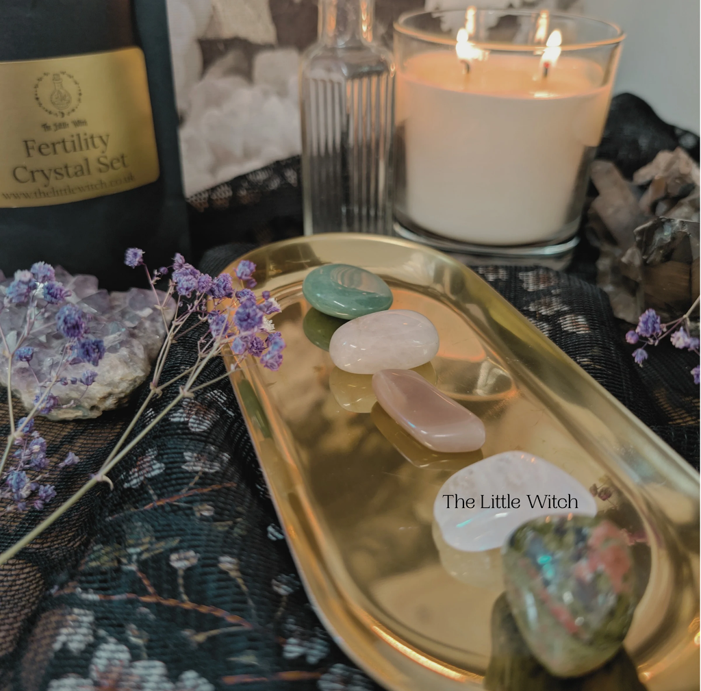 Crystal set and candle on a gold tray with a mystical ambiance.