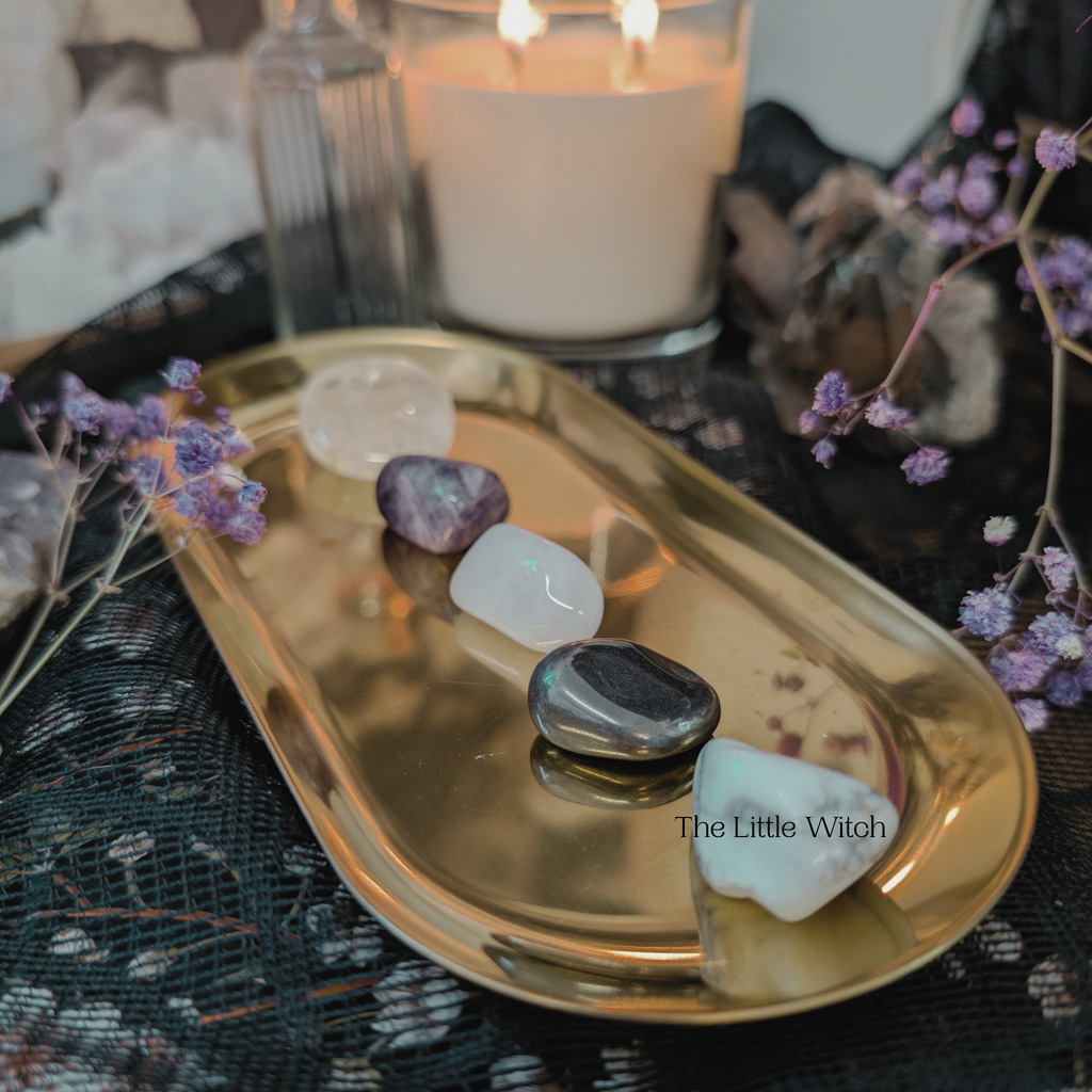 Tray with crystals and a candle on a decorative surface