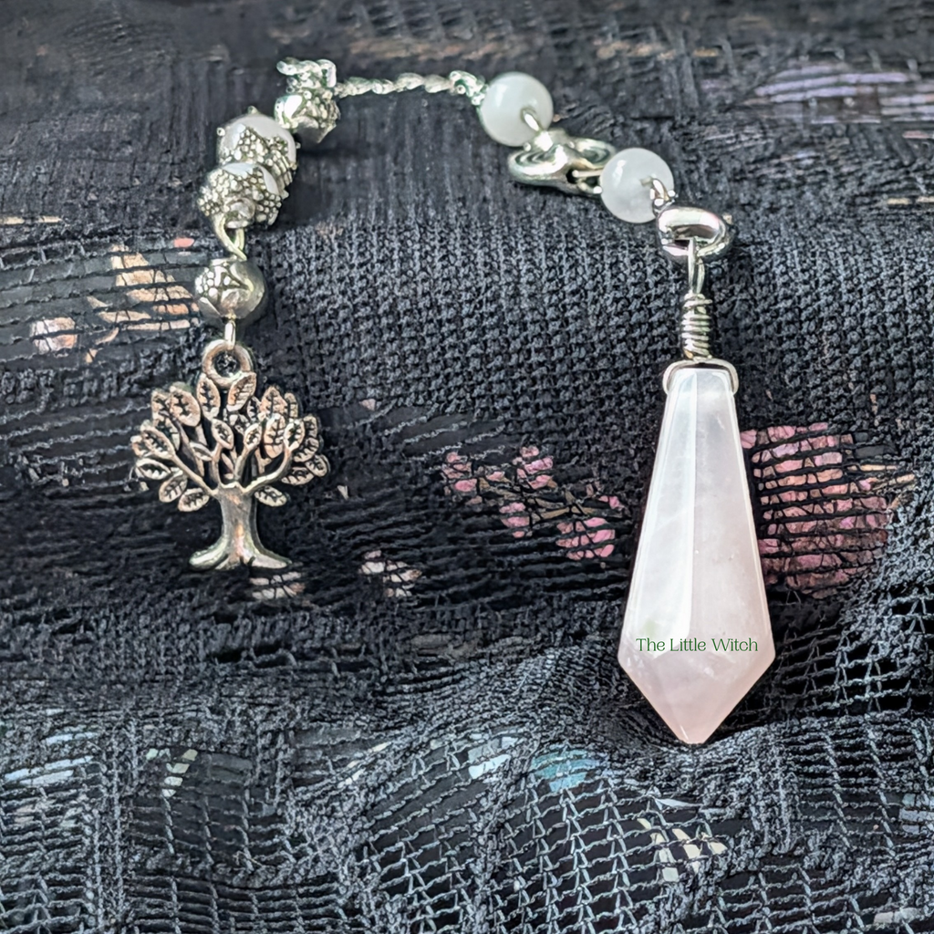Tree of life charm on the end of a silver chain with rose quartz faceted pendulum