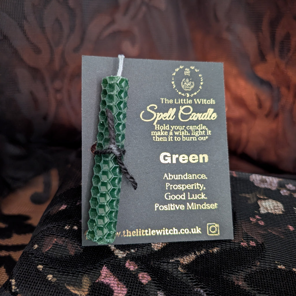 green beeswax candle mounted on The Little Witch black and gold card 
