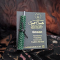 green beeswax candle mounted on The Little Witch black and gold card 