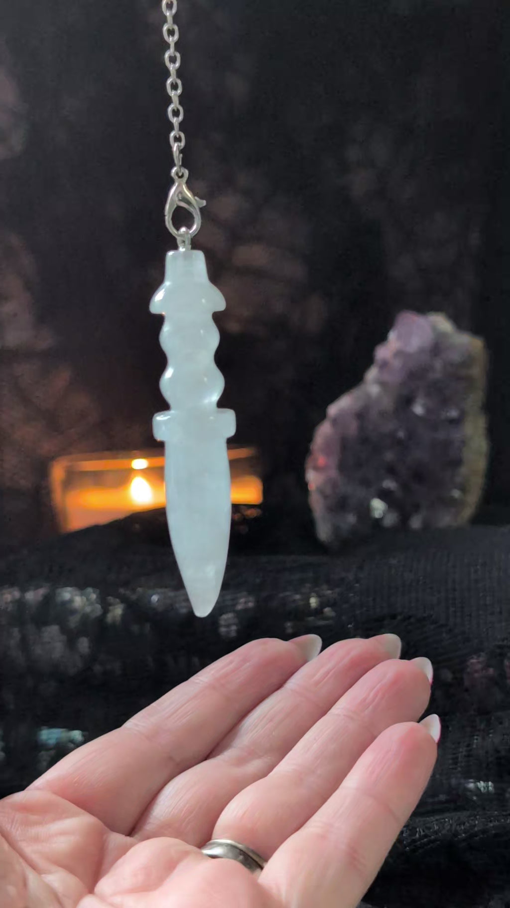 The Little Witch aesthetic background with a video of the clear quartz pendulum answering yes or no questions 