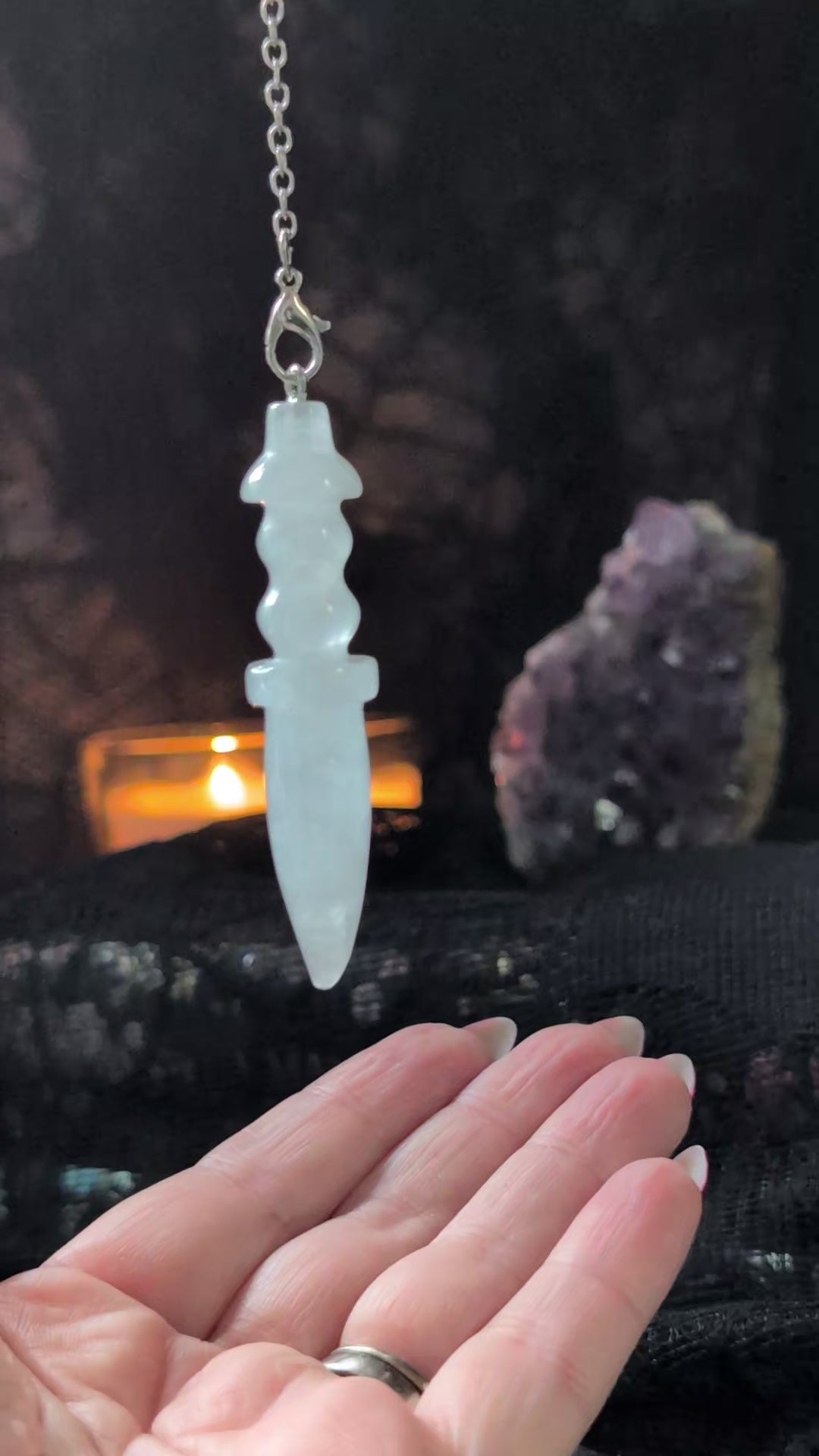 The Little Witch aesthetic background with a video of the clear quartz pendulum answering yes or no questions 