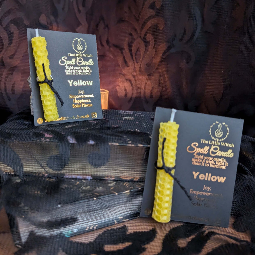 Yellow beeswax candle mounted onto luxury black card with gold The Little Witch foiled branding